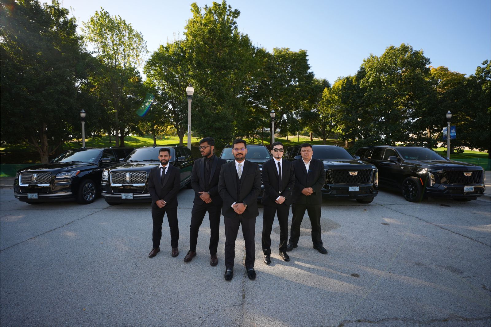 Vellaro's uniformed chauffeur team standing with the executive fleet